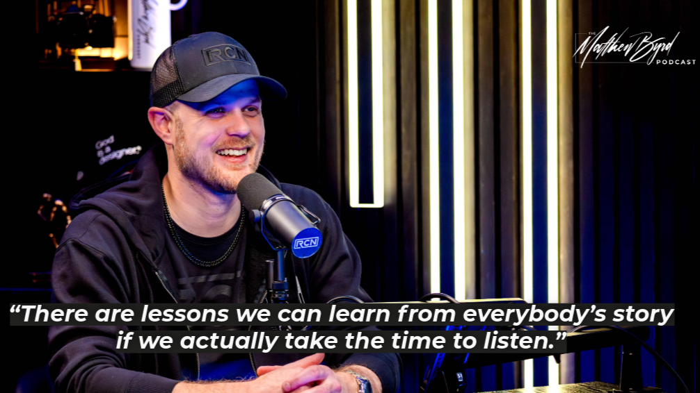 A man in a black cap and hoodie speaking into a microphone during a podcast interview, with a colorful background and the text quote: 'There are lessons we can learn from everybody’s story if we actually take the time to listen.'