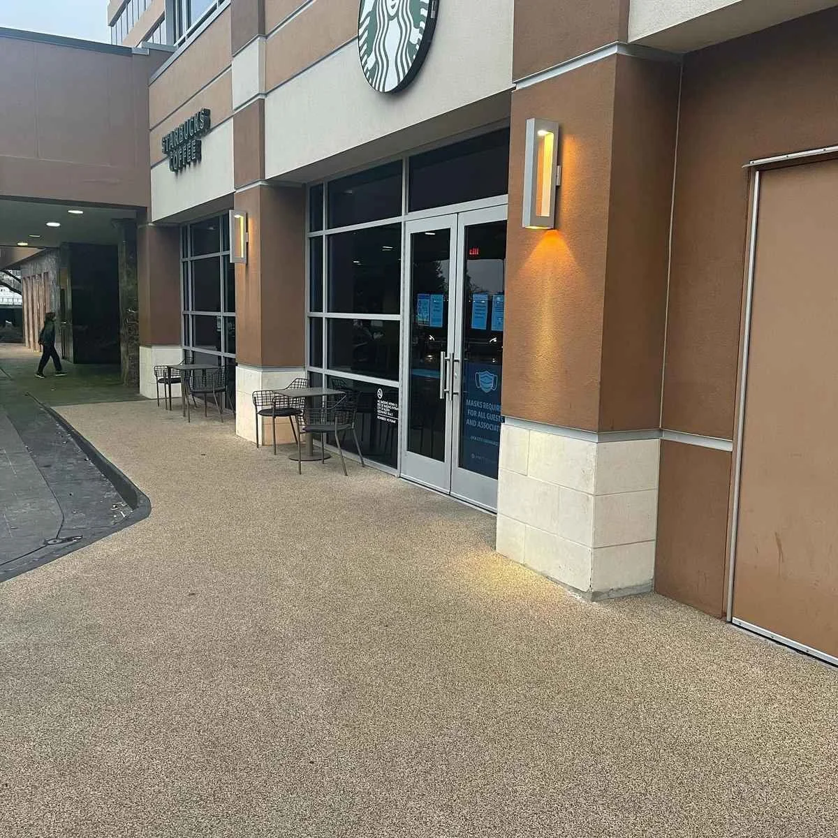 Starbucks storefront entrance with glass doors and outdoor seating