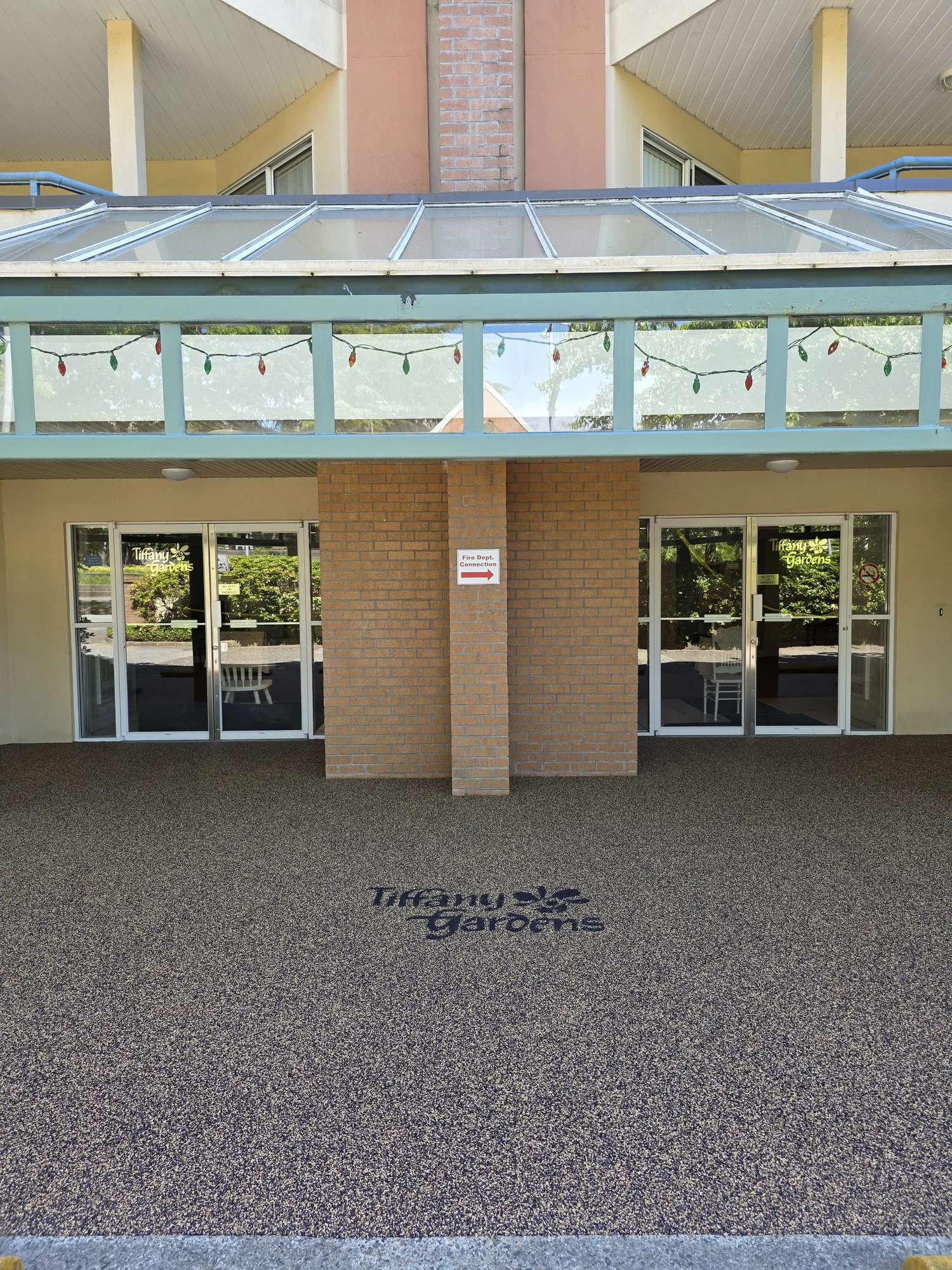 Tiffany Gardens commercial building entrance with custom rubber surfacing and branded entrance design