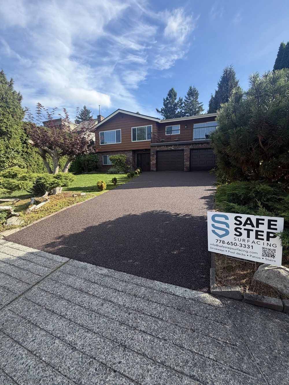 Residential driveway project with a Safe Step sign