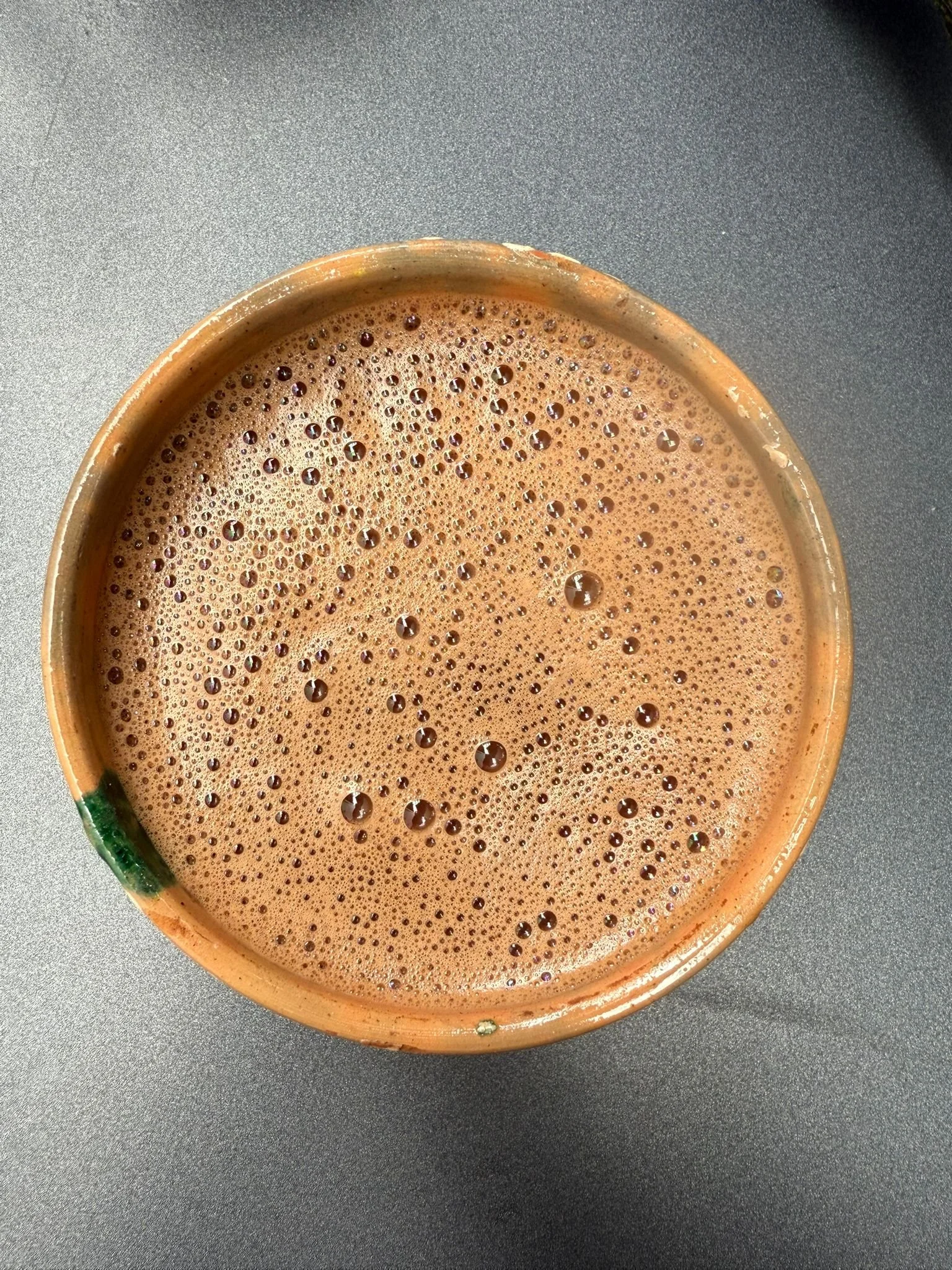 Cup of freshly prepared ceremonial cacao with frothy surface