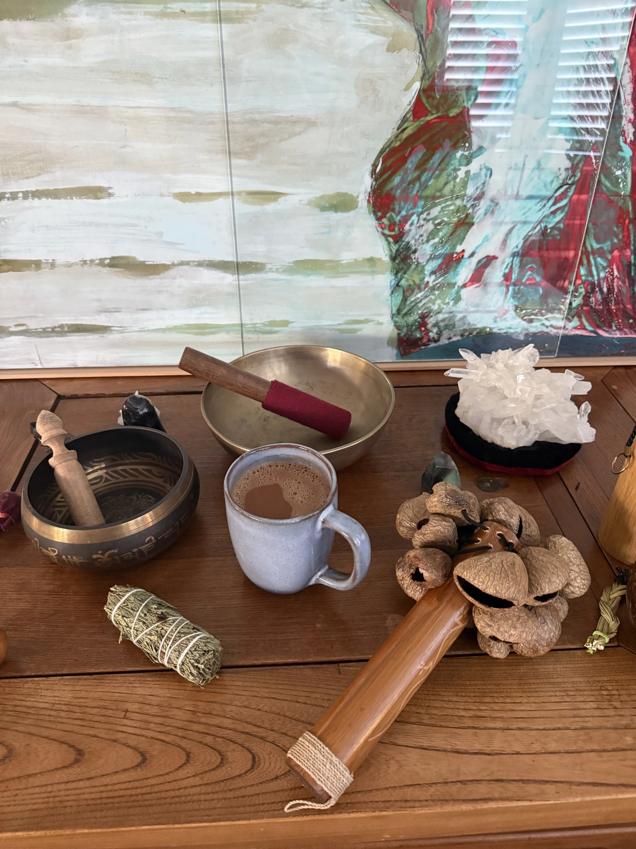 Ceremonial cacao preparation setup with spices, cups, and ritual tools