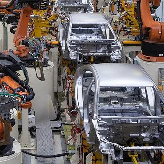 Automobile assembly line with robots assembling car bodies.