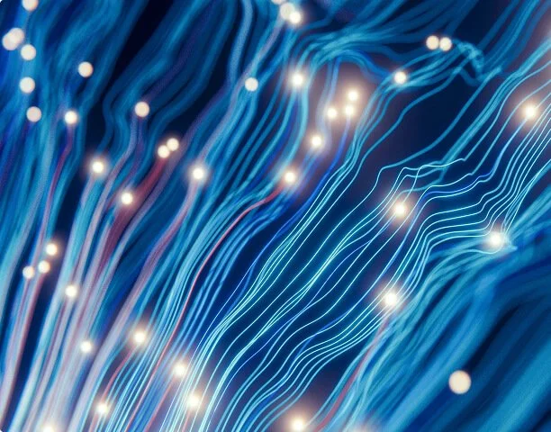 Blue fiber optic cables with glowing white light points along the strands.