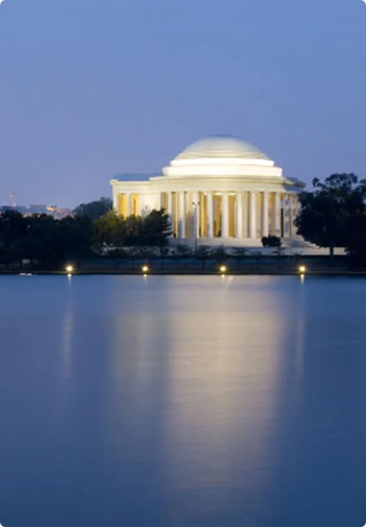 The Lincoln Memorial at night, reflected in the water of the reflecting pool.