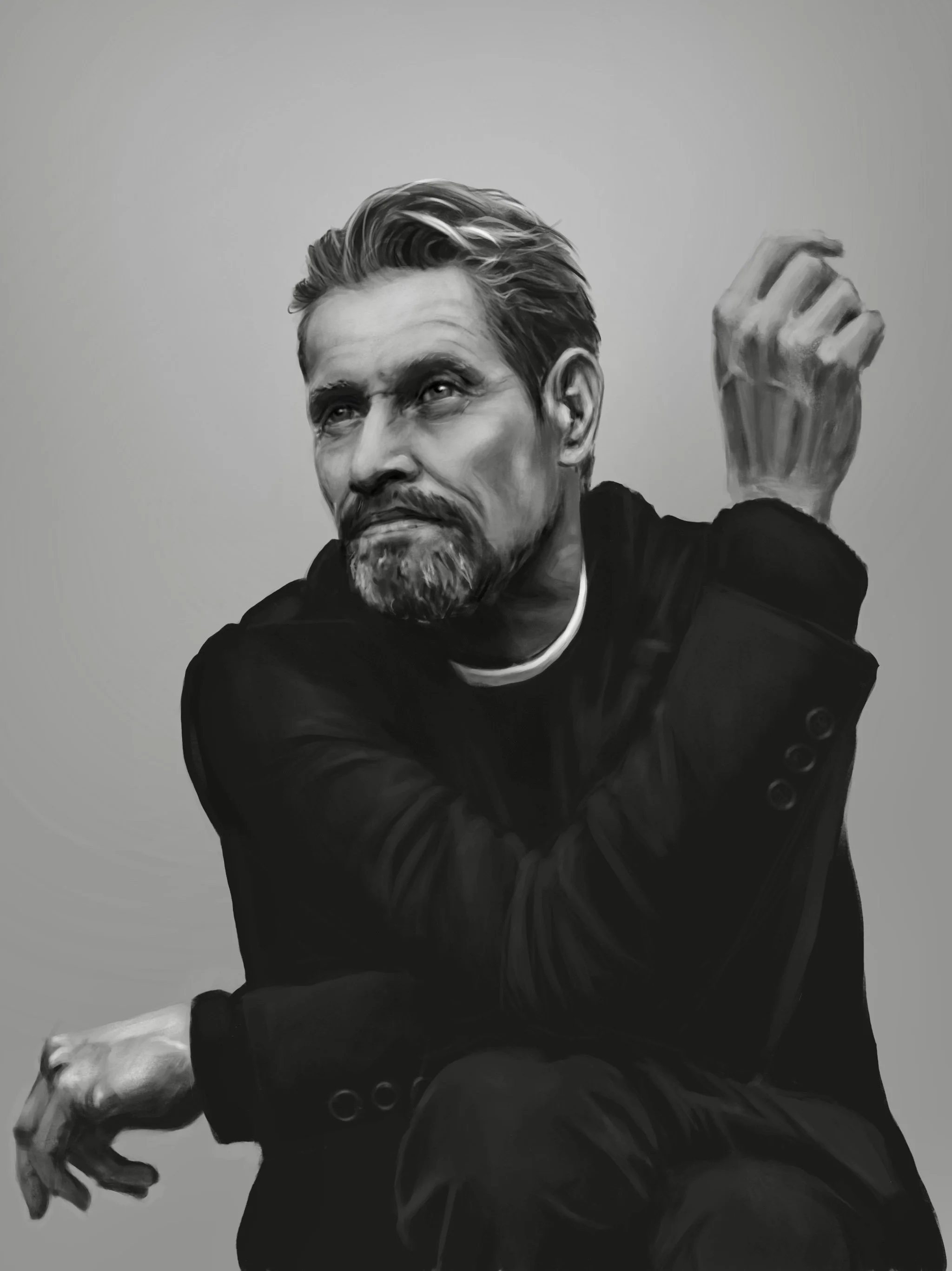 Black and white portrait of a man with a beard and styled hair, wearing a dark blazer, sitting with one arm resting on his knee and the other raised near his head, gazing thoughtfully.