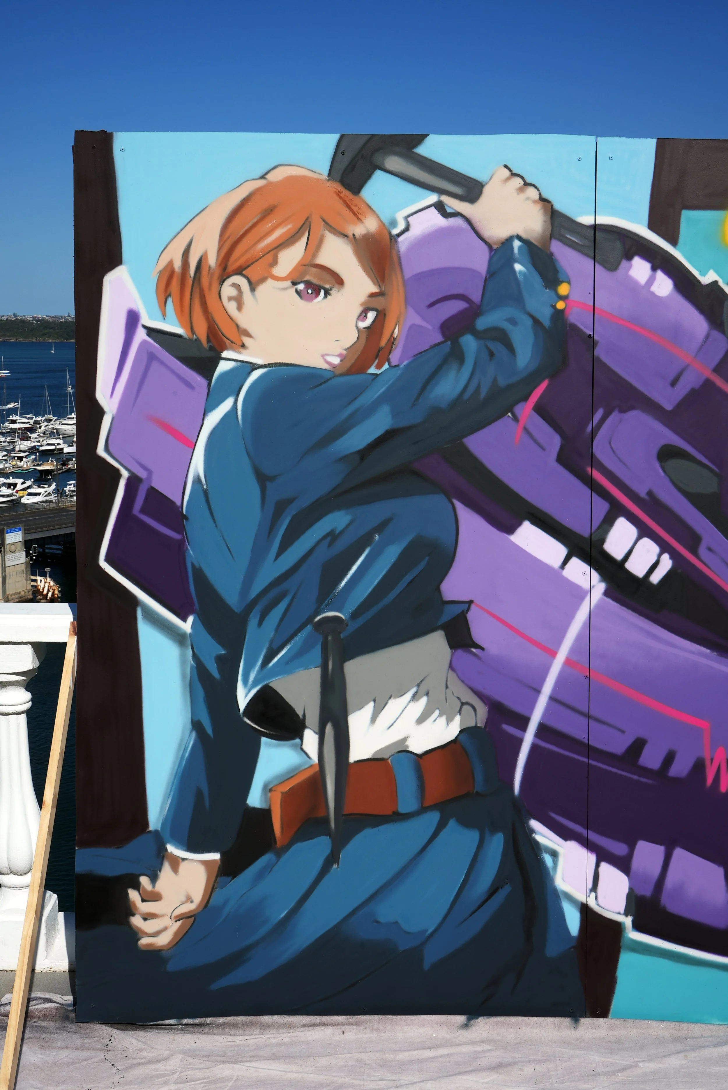 A colorful mural of a young woman with short reddish-brown hair, holding a large axe placed on her shoulder. She is dressed in a dark blue jacket, white shirt, and brown belt, set against a purple and black abstract background.