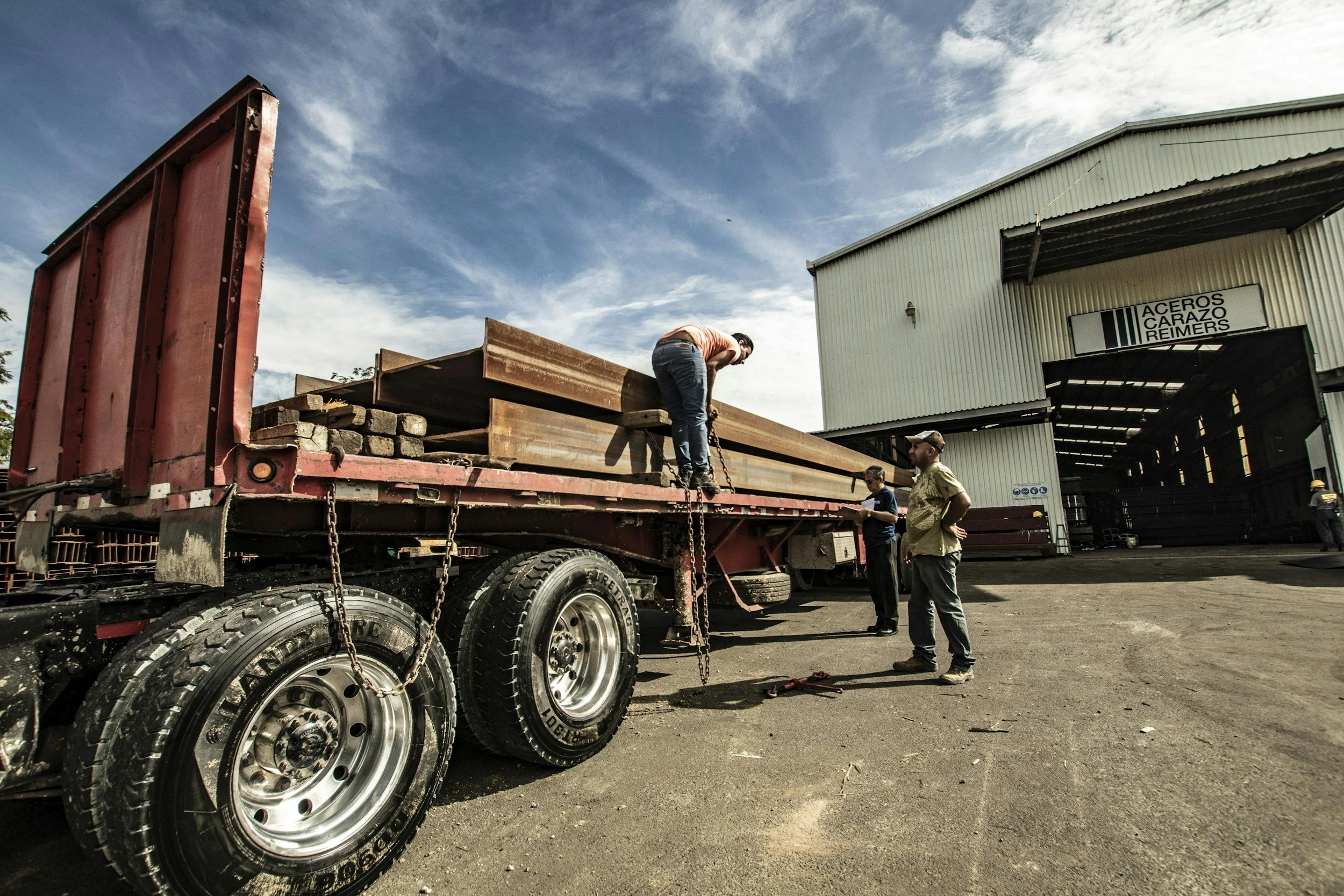 Proper load securement using straps, chains, and edge protection.