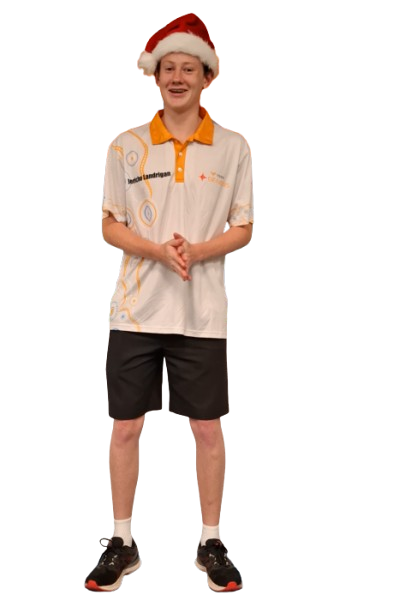 Young person wearing a Santa hat, white and yellow sports shirt, black shorts, and athletic shoes, standing with hands clasped, against a black background.