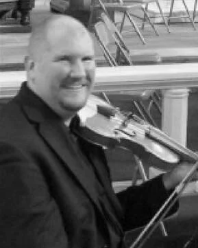 Man in a suit playing a violin