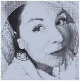 Close-up of a woman's face with dark hair, wide eyes, and a slight smile.