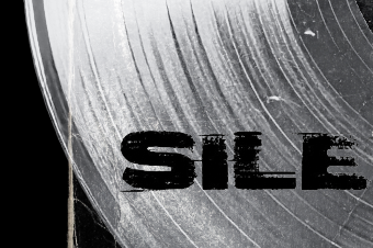 Close-up of a metallic surface with the word 'SILE' printed on it.