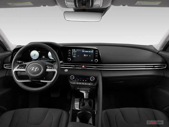 Interior of a Hyundai car showing the dashboard, steering wheel, and center console with infotainment screen and climate controls.