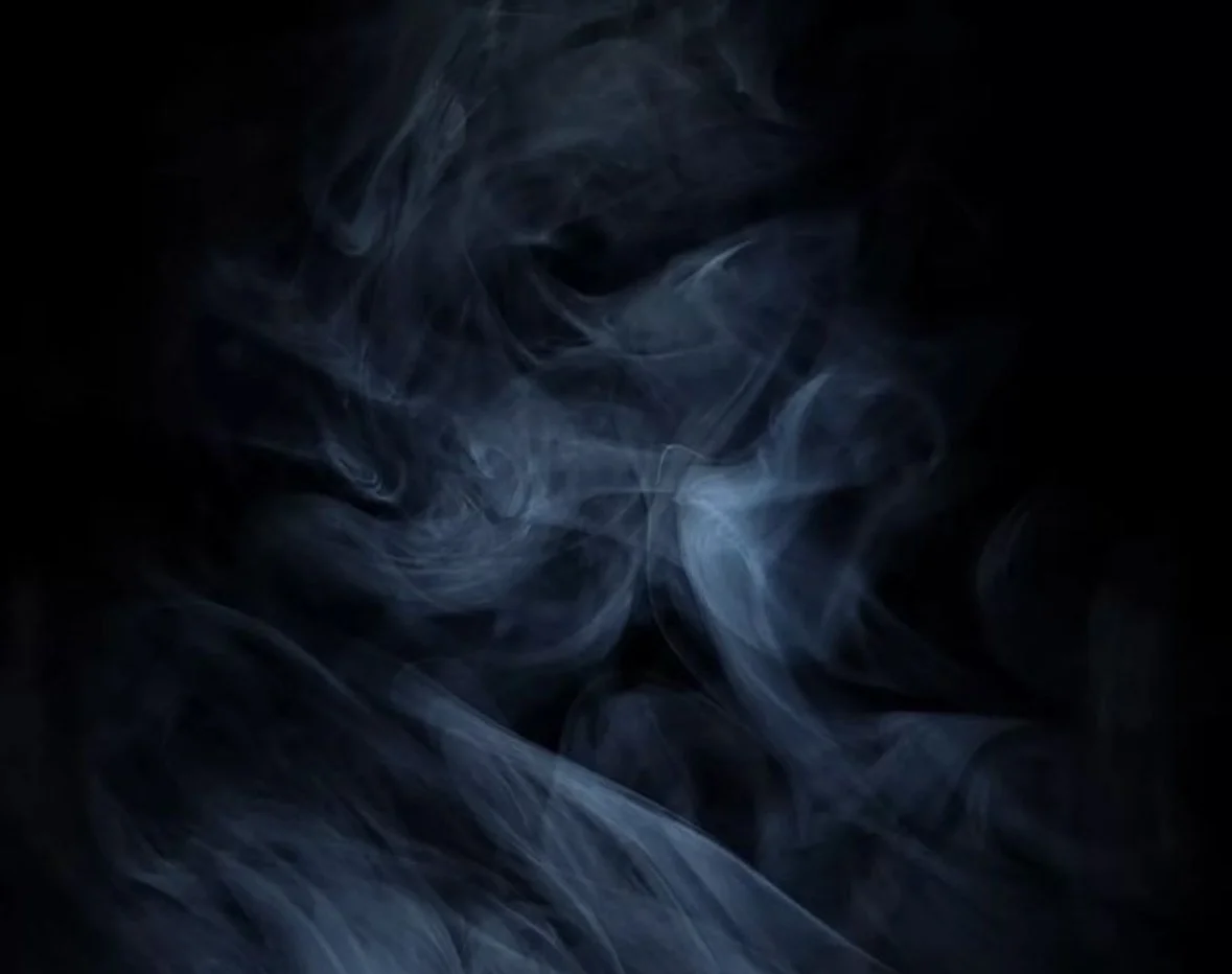 Swirling wisps of blue and gray smoke against a black background.