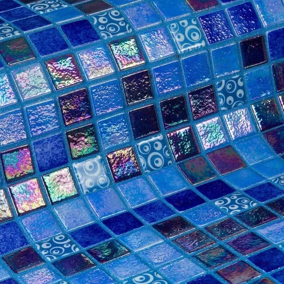Close-up of a mosaic tiled surface with various shades of blue and iridescent tiles, some with swirl patterns.