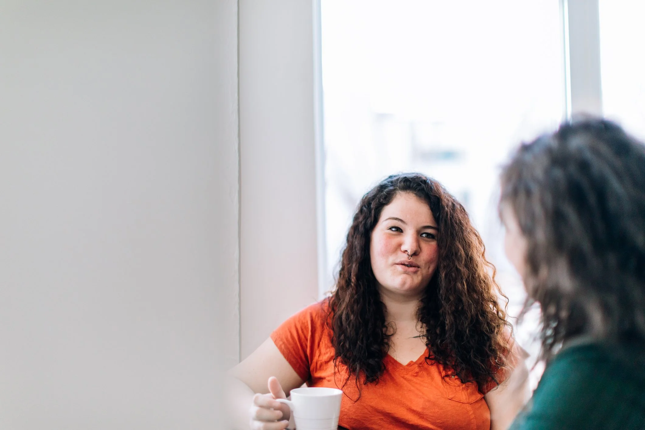A female student having coffee with a friend