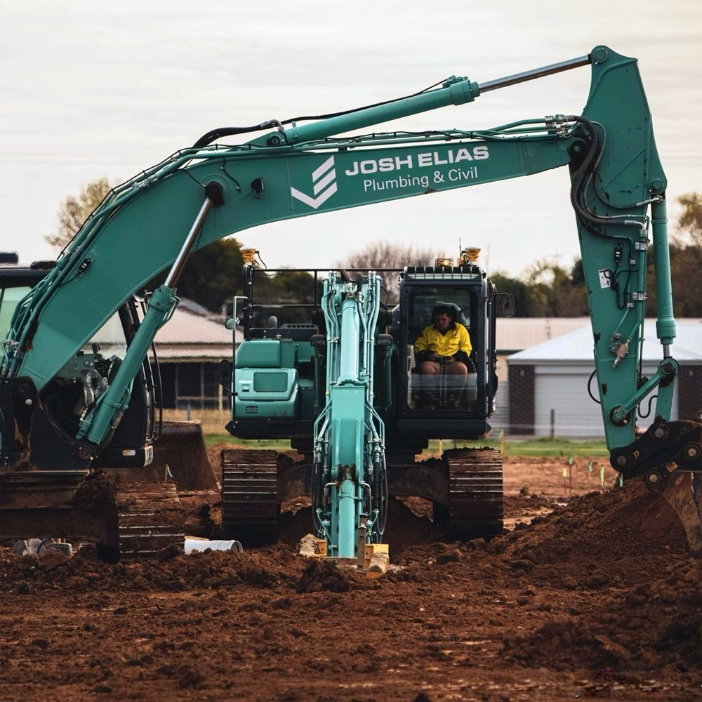 JEPC construction excavator working on a dirt site with a personnel inside