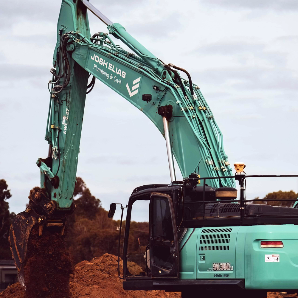 A JEPC excavator operating on dirt at a construction site