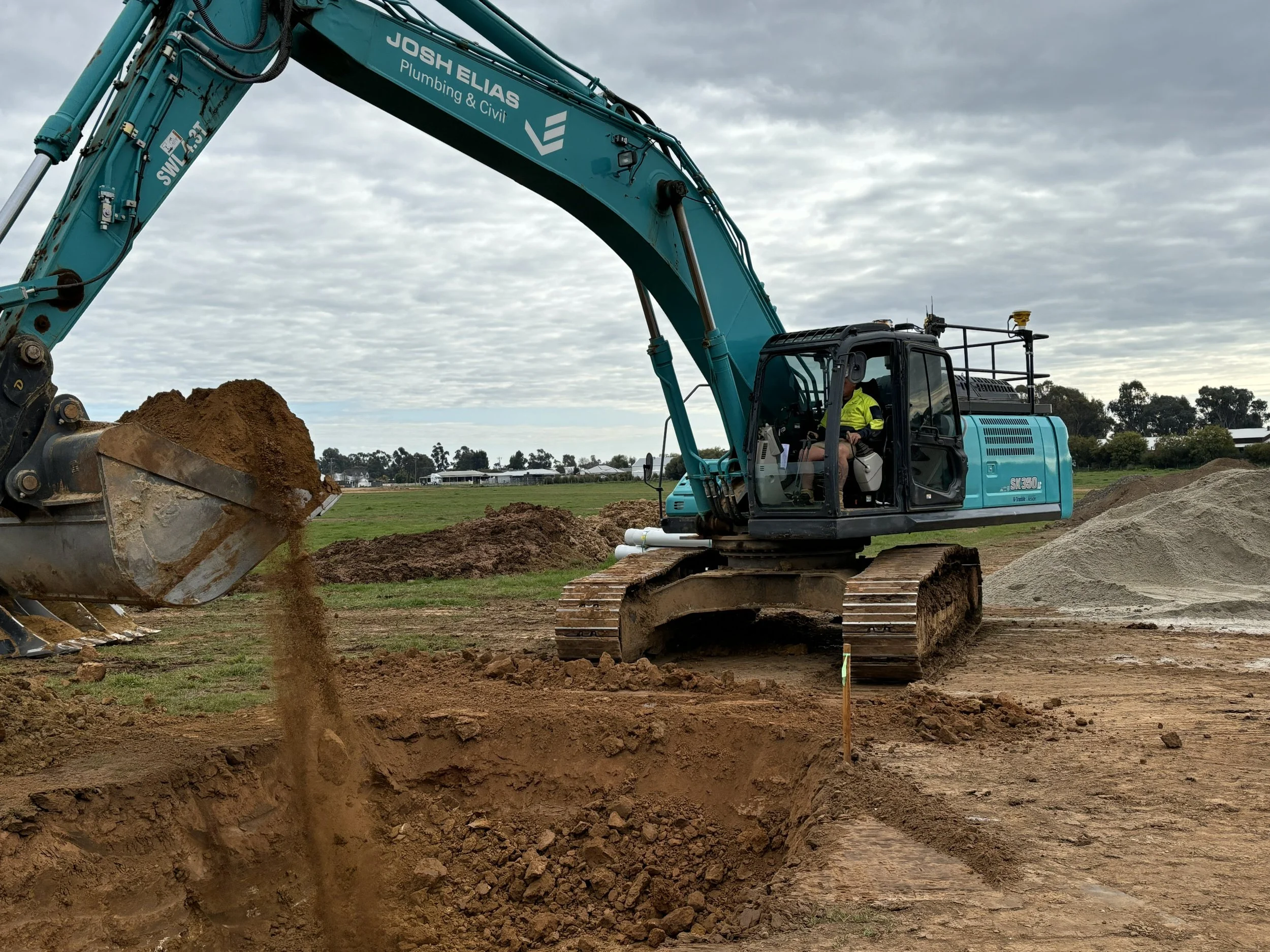 JEPC personnel operating the excavator digging into the earth on a construction site