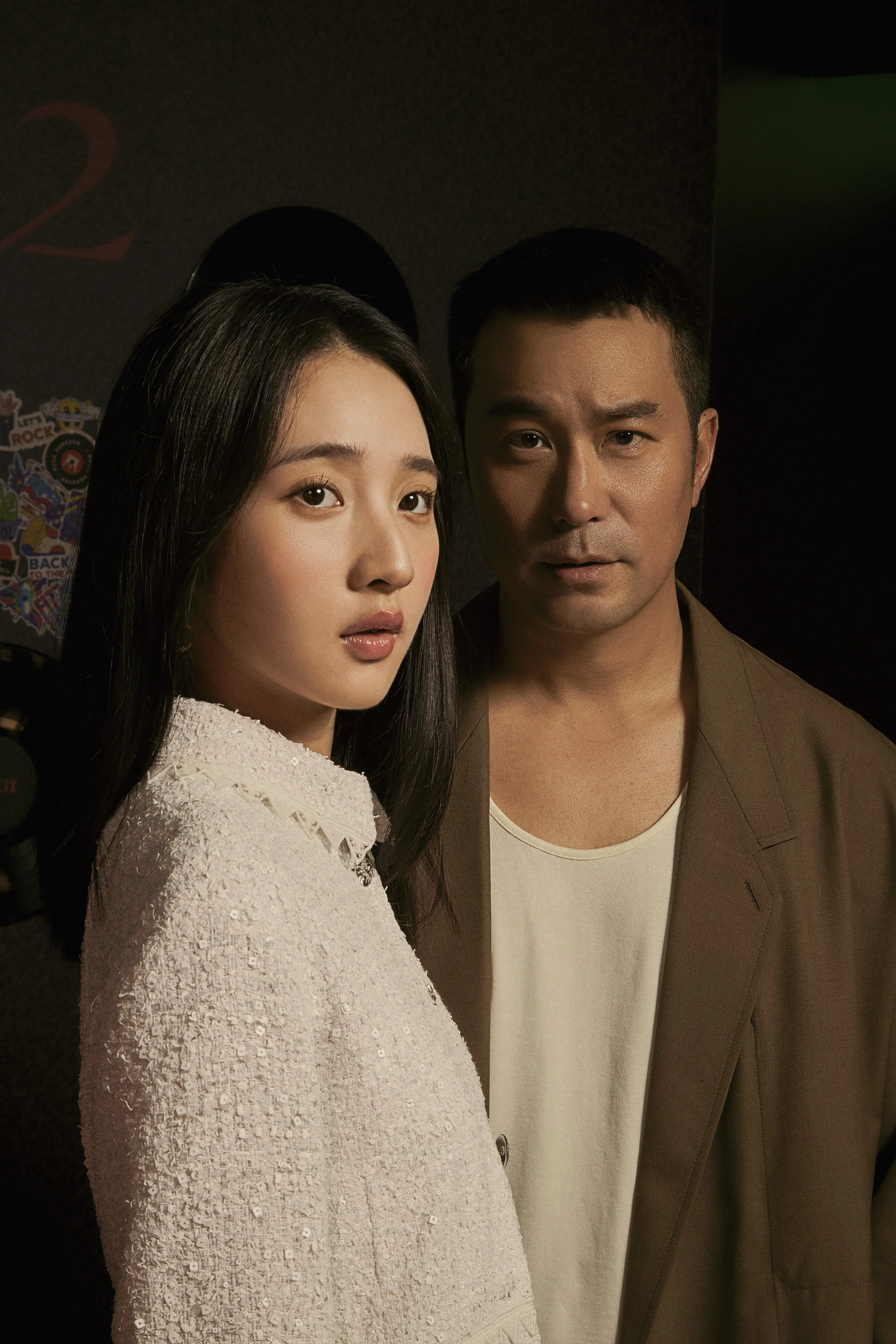 Dramatic portrait of the lead actors from The Victim's Game S2, photographed in a moody, cinematic setting during a Netflix promotional event.