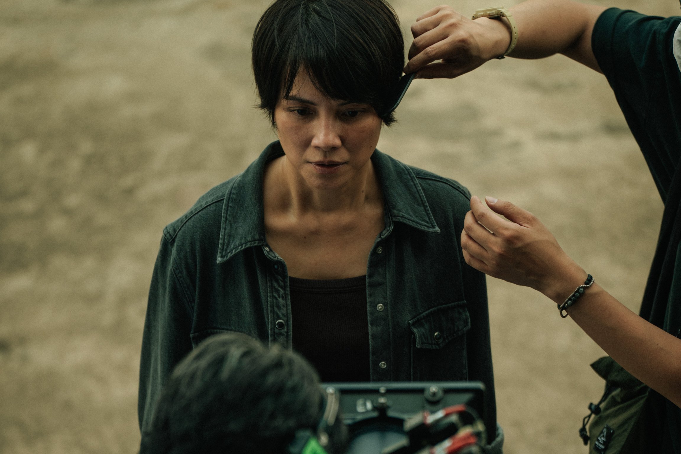 Behind-the-scenes moment capturing on-set preparation and camera proximity during a film shoot.