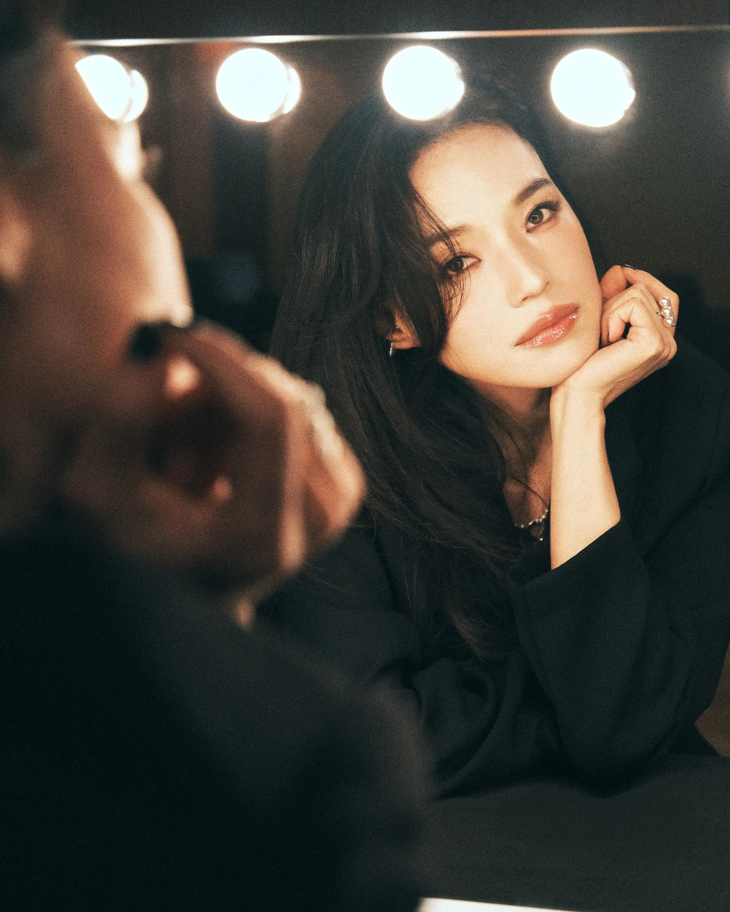 Editorial portrait of an actress photographed in a dressing room mirror during the 2025 Busan International Film Festival.