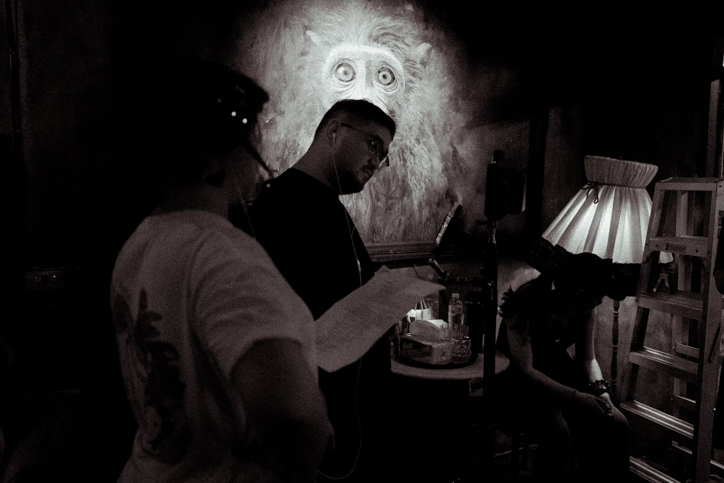 Behind-the-scenes moment of the director reviewing notes during a production shoot.