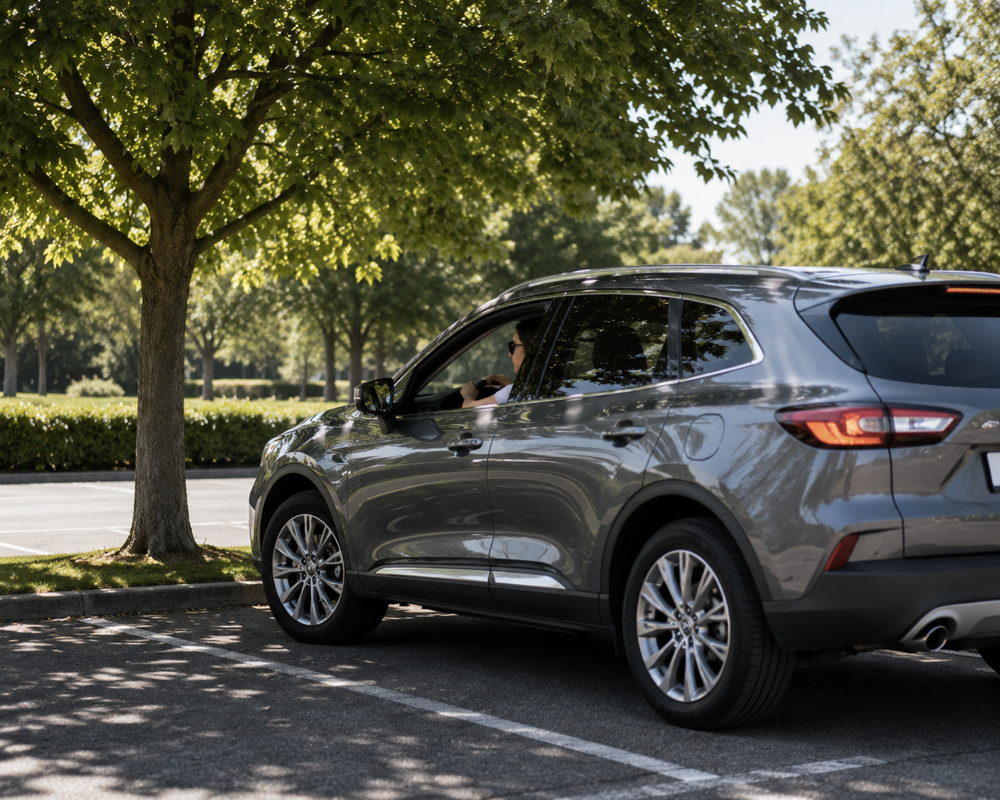 Driver parks a car in the shade during hot summer weather to help reduce the cabin temperature and protect the dashboard, seats and steering wheel from heat damage. Parking in the shade is a simple way to prepare your car for summer driving.