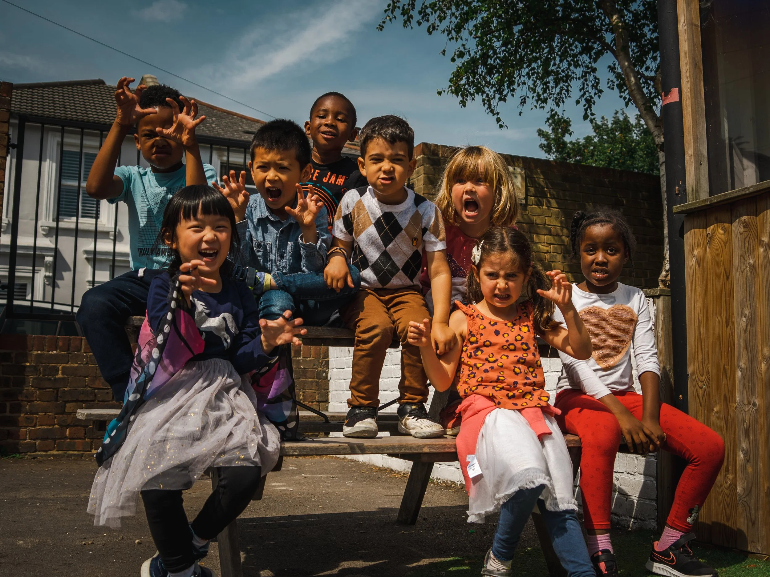 Group of children sitting together enjoying their day at Global Camps holiday camp