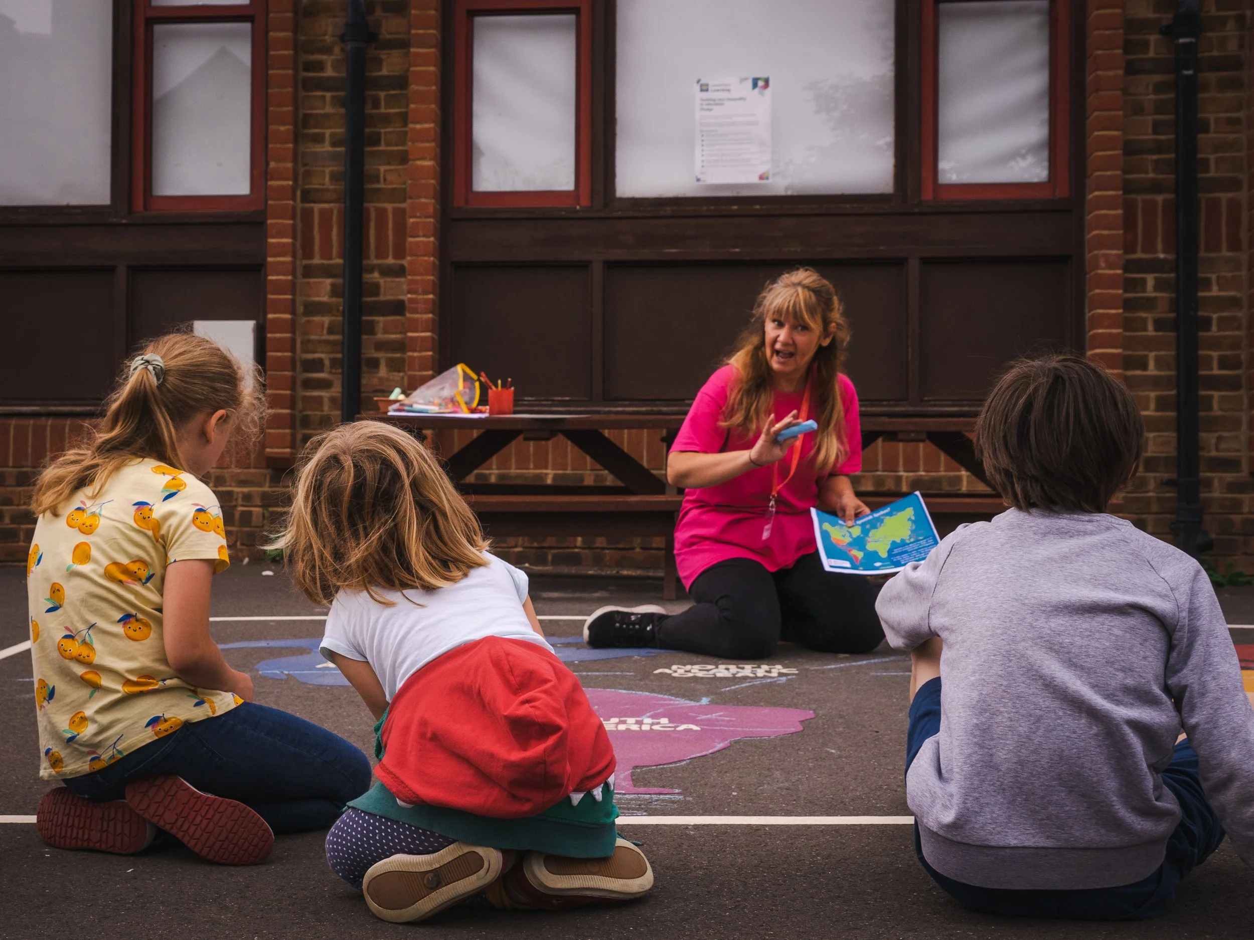 Children taking part in an adult led activity outside at Global Camps