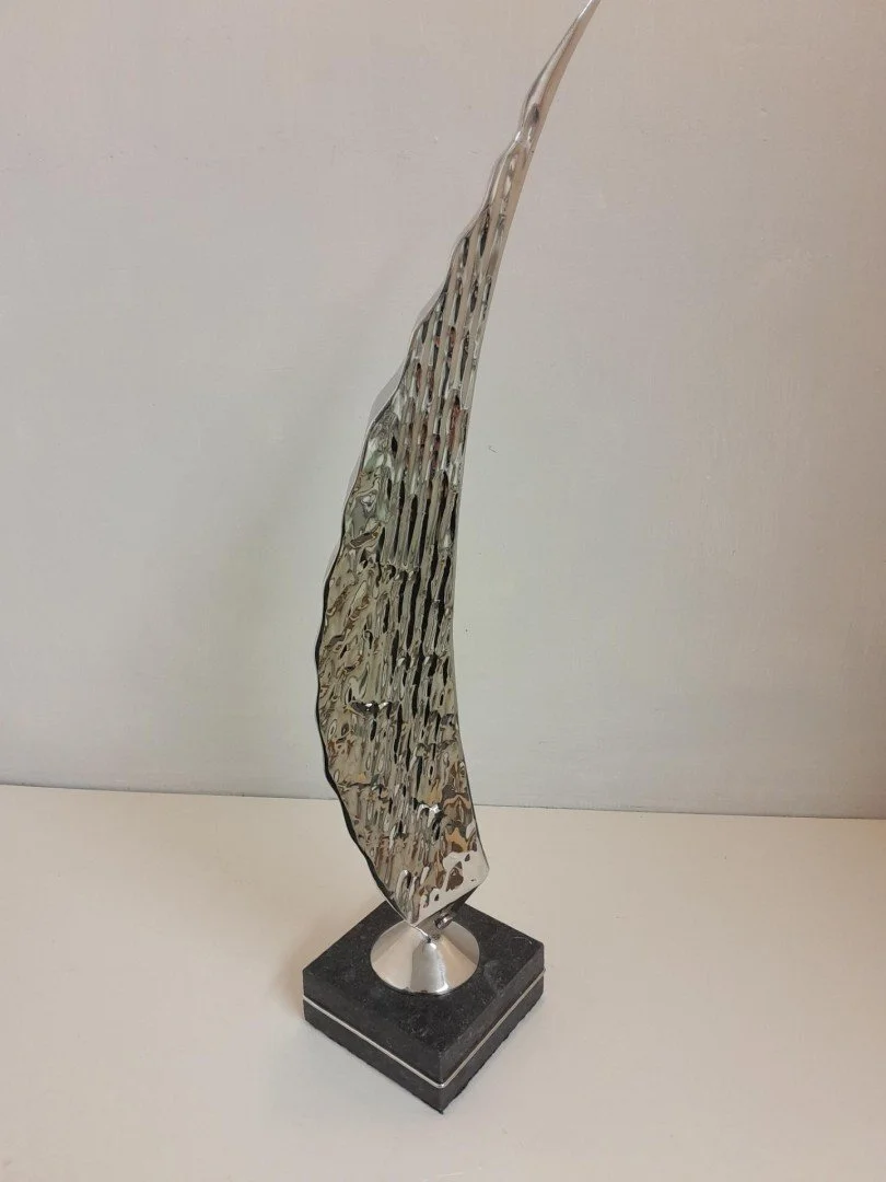   Spinnaker  
   SCULPTURE PRIZE WINNER TIE 
 £1,300
 OrigMal
 Stainless Steel on Composite Base
 Sculpture Size: 51cm x 10cm x 11cm