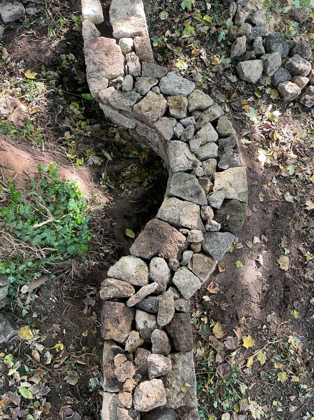 rebuilding of drystack church wall to accommodate tree; Oxfordshire, United Kingdom