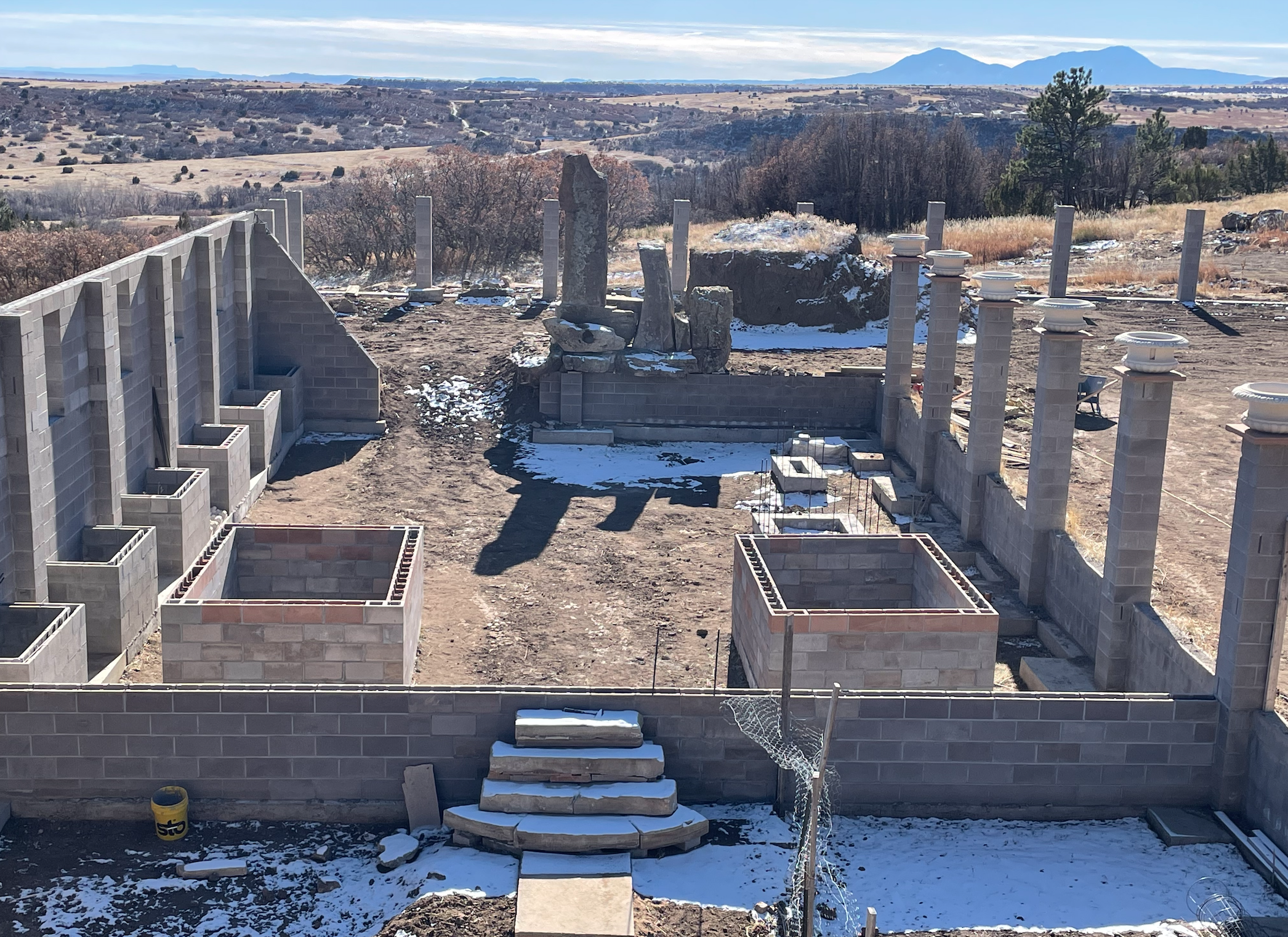 ongoing construction of koi pond with boulder waterfall