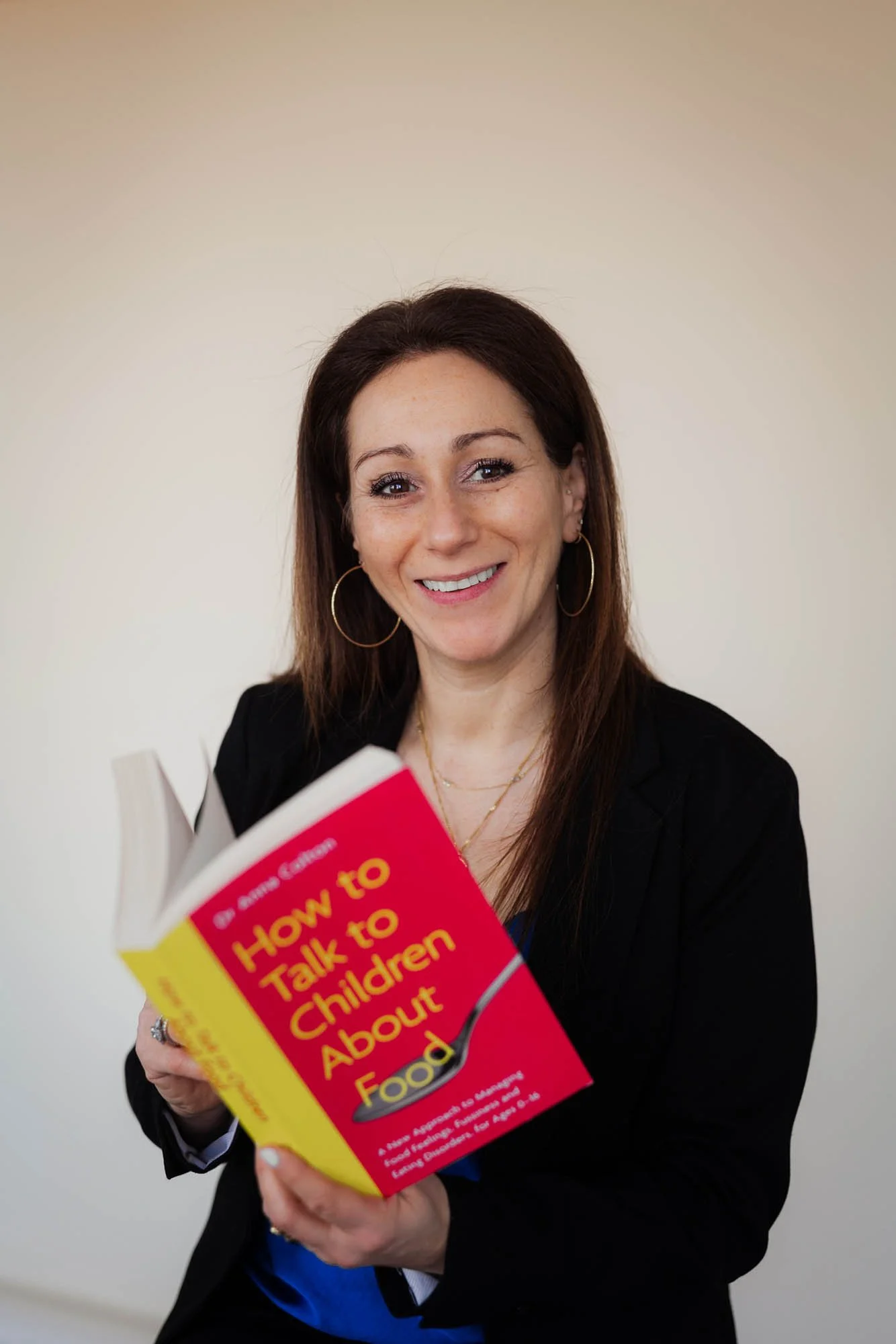 Author holding book about food and children