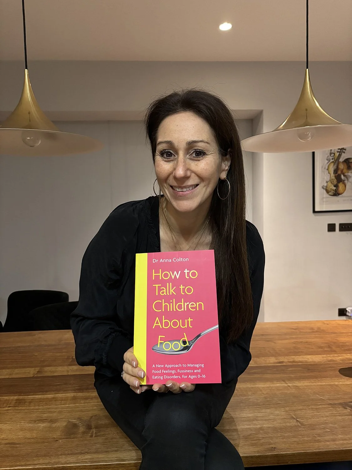 Author holding book about food and children