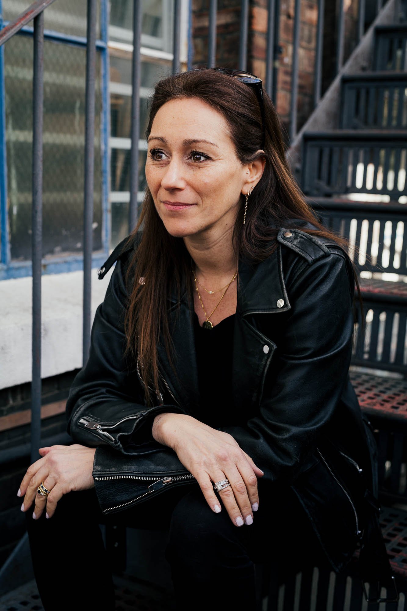 Dr Anna Colton sat on steps wearing leather jacket