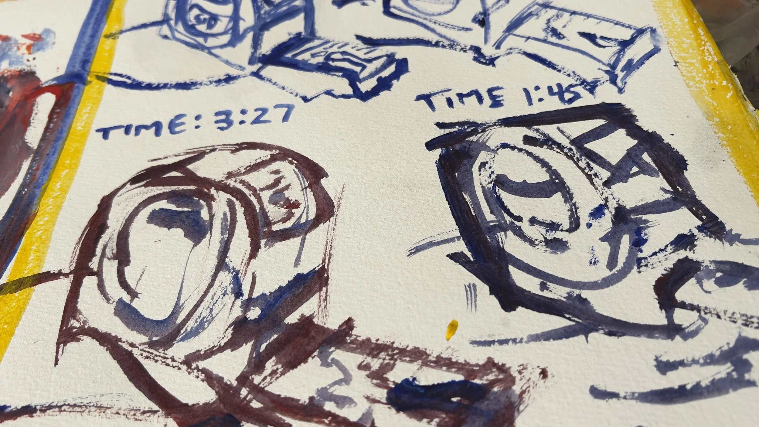A close-up of a hand-drawn sketch on white paper, featuring abstract shapes and lines in blue and red colors. The image shows timestamps '3:27' and '1:45' next to the sketches.