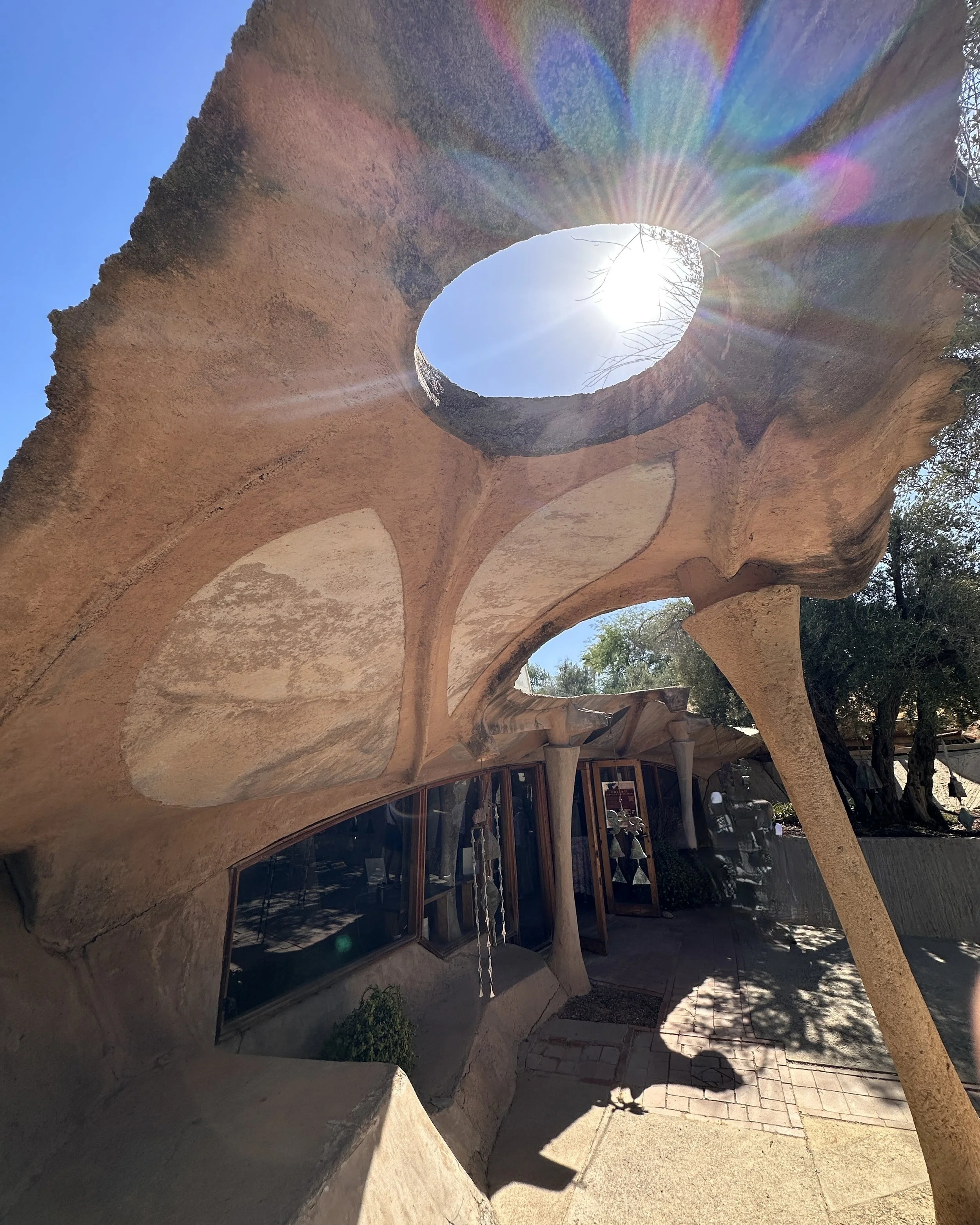 Look up.
See differently.
Let the light lead you.

✨🚐❤️

Before I even knew much about Cosanti, I knew this place would ask me to 'look up'.

The curves, the openings, the bells, the way the desert light moves through the space &mdash; It all feels 