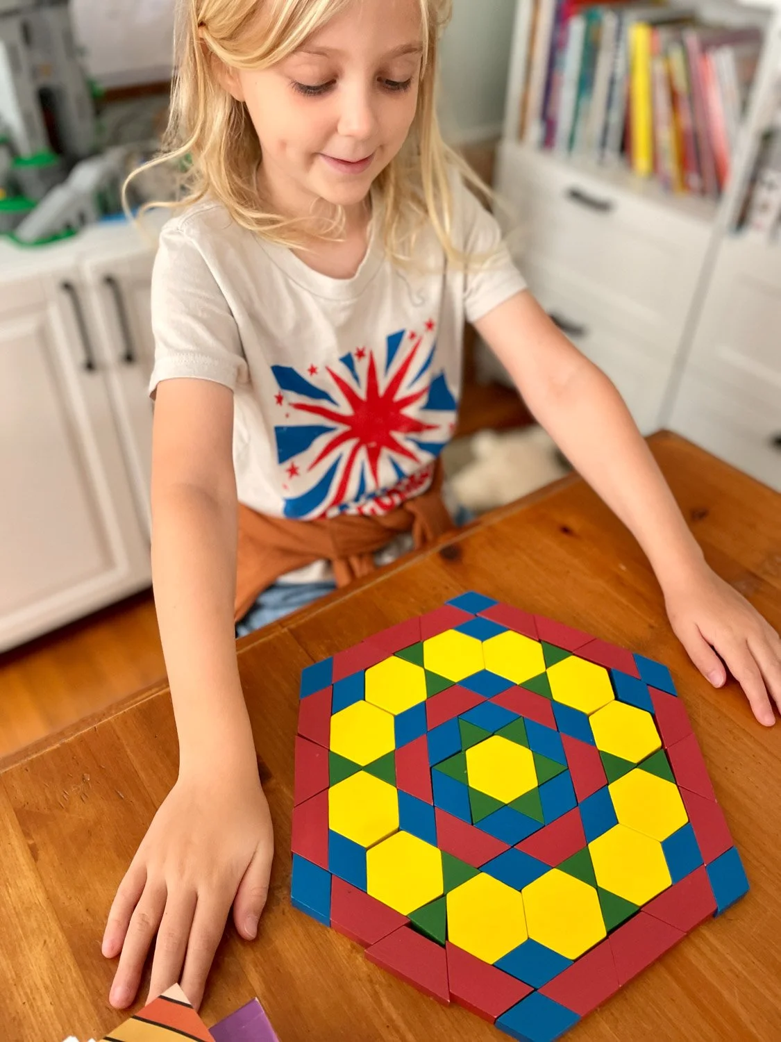 girl admiring her pattern block mosaic