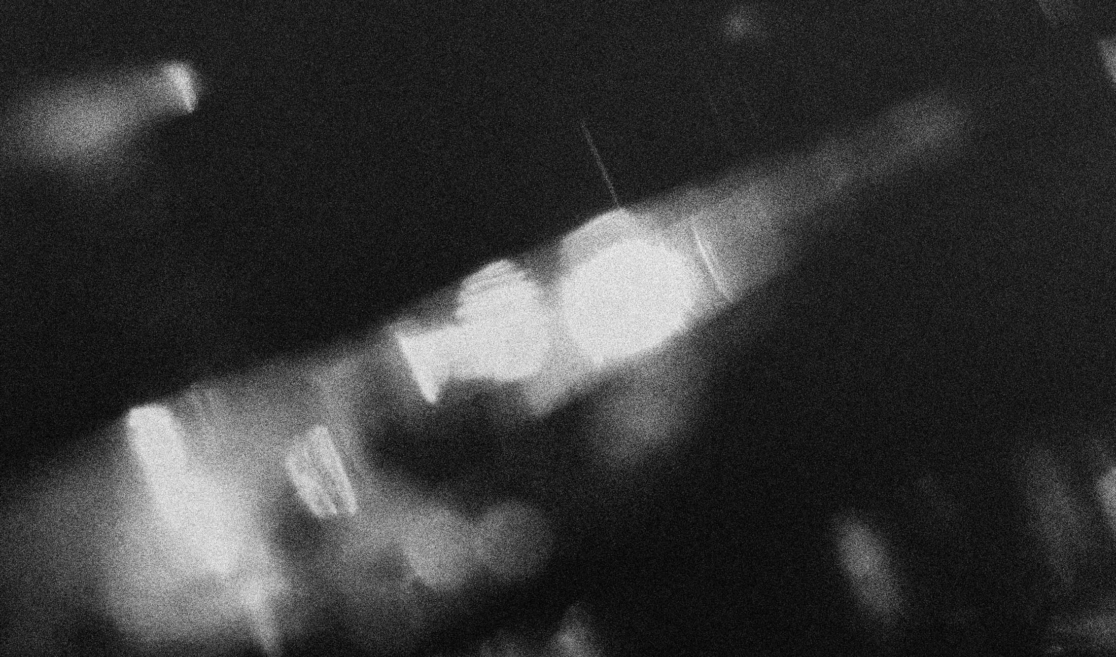 Black and white image of a hand holding a lighter with a flame.