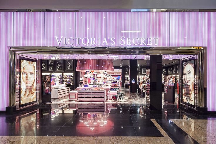 Victoria's Secret store entrance with pink and purple colors and large images of models.