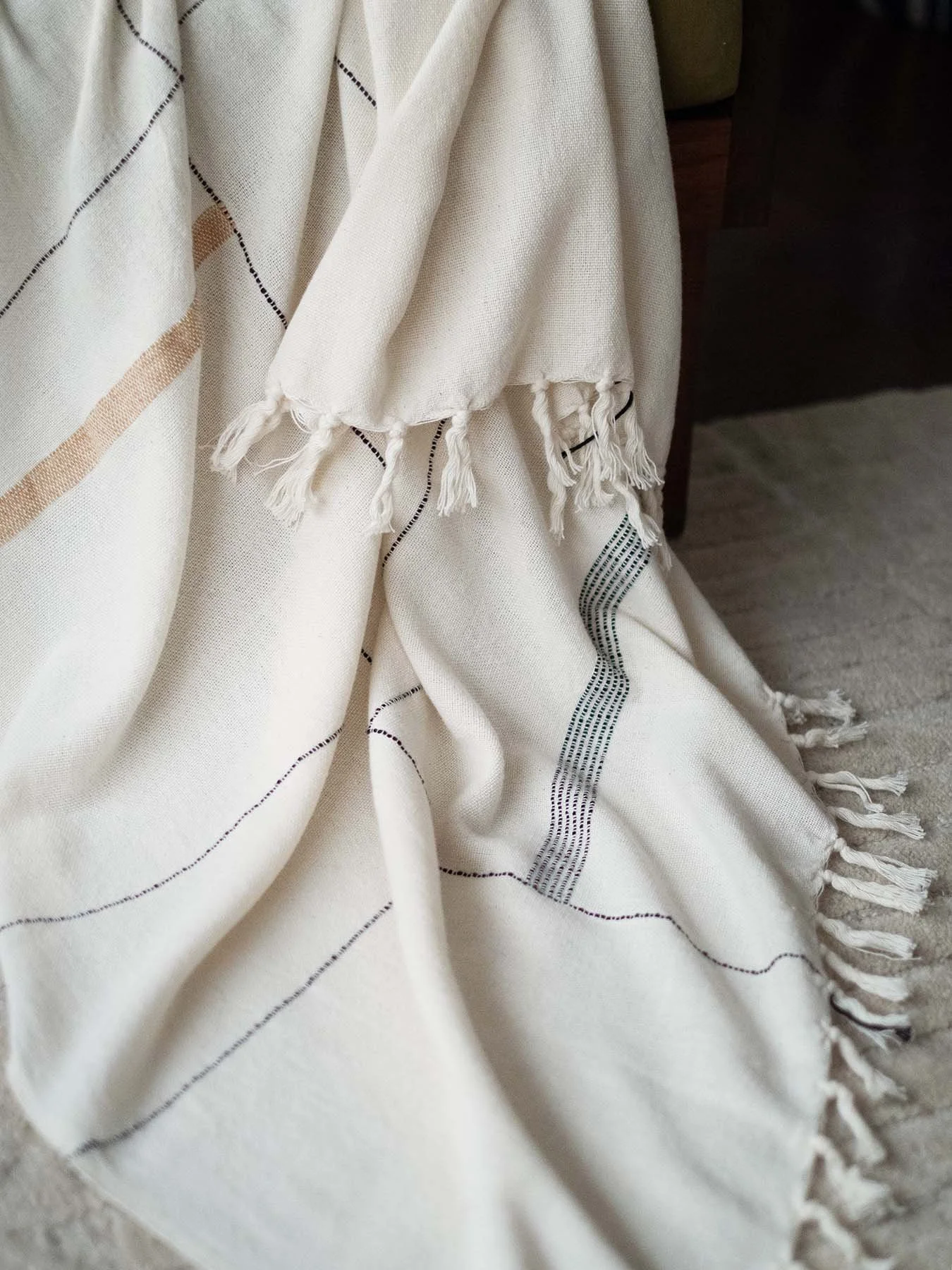 an image of the Nadi Throw draped over an armchair