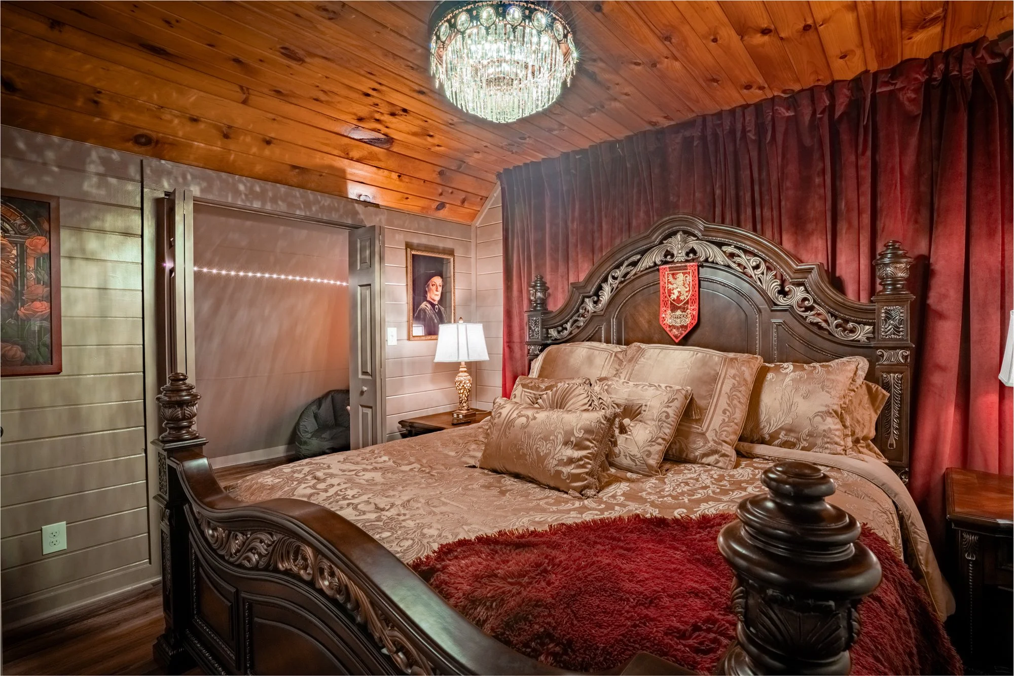 The side view of the bed in the gryffindor room at the harry potter airbnb