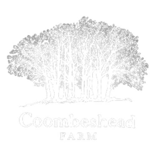 White tree illustration above the text 'Coombeshead Farm' on a black background.