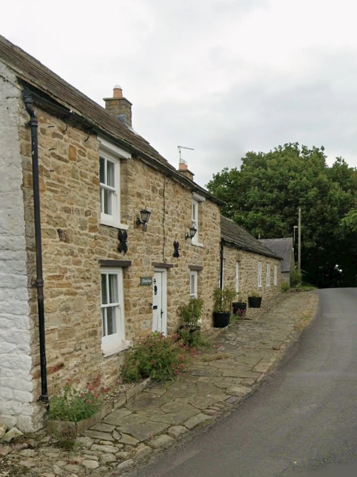 A charming, grade II stone cottage on a curved road in Hexhamshire repointed in lime mortar by Northumbrian Pointing.