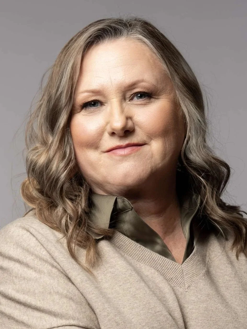 Headshot of Andrea Best wearing a beige sweater