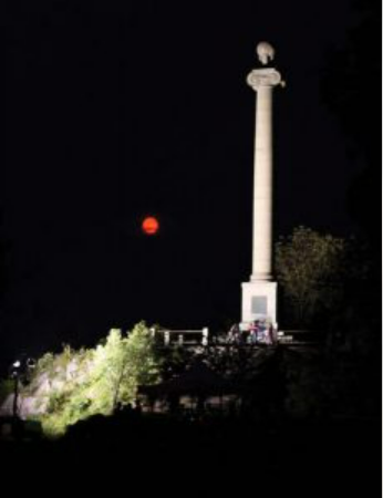 Rumsey Monument Lighted with a red moon behind
