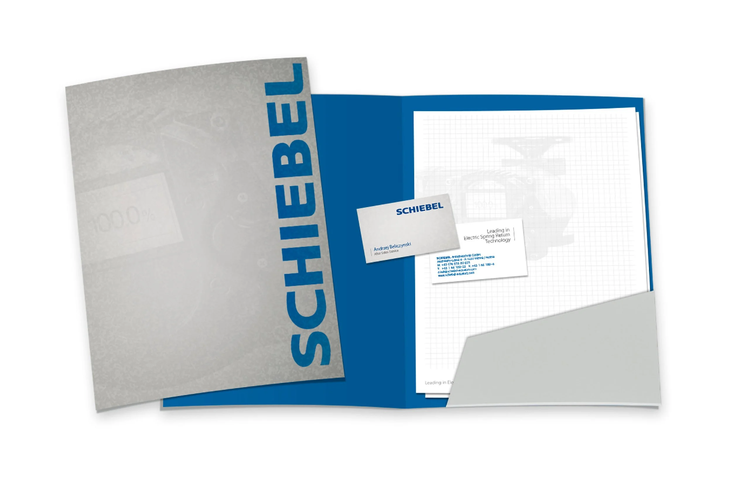 Open presentation folder with business cards and a notepad inside, branding with blue and grey colors and the name 'Schiebel'.