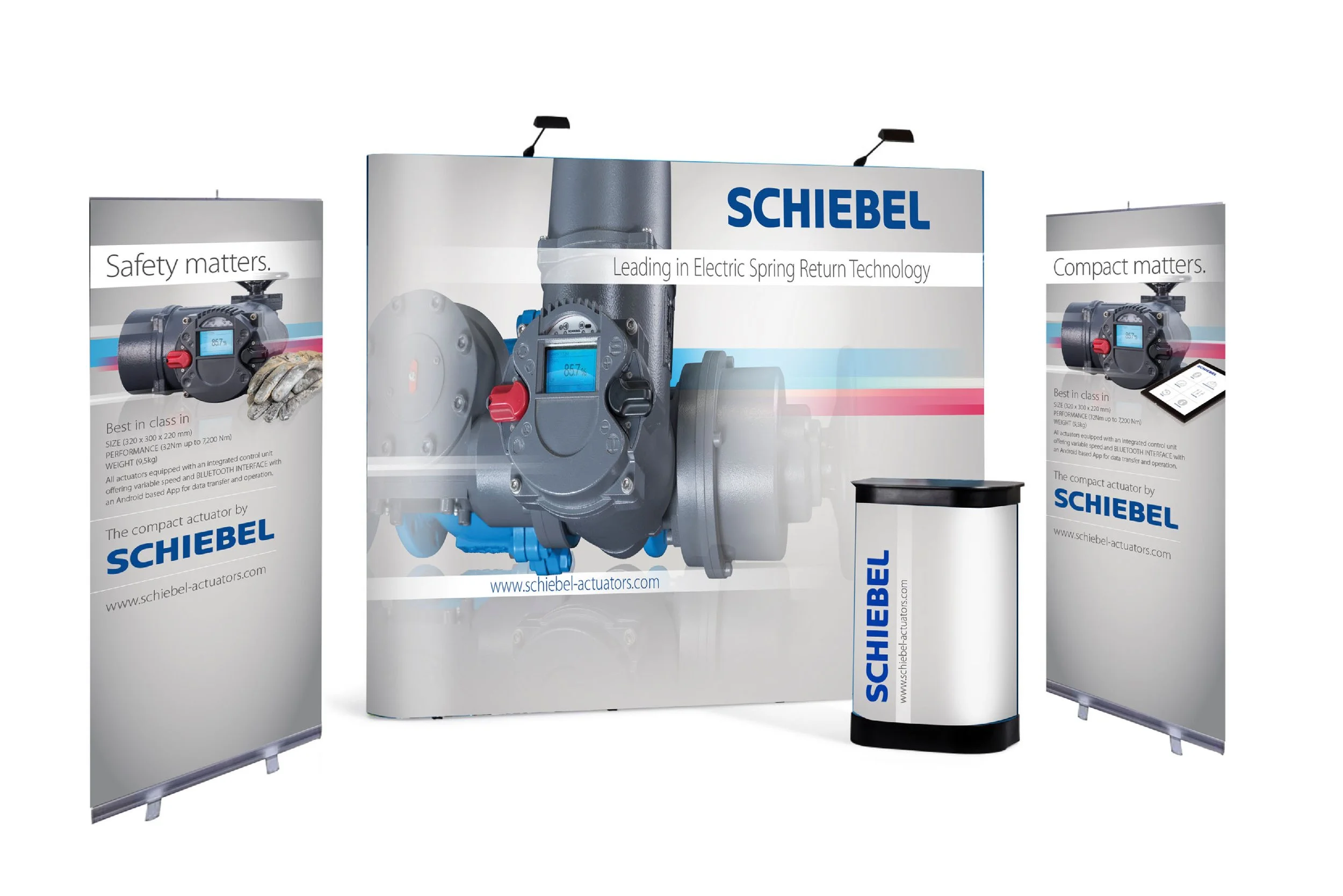 Industrial display booth showcasing Schiebel electric actuator with banners highlighting safety, compactness, and performance features.