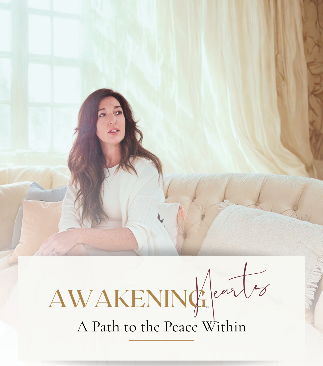 A woman with long brown hair sitting on a beige sofa in a bright room with cream curtains and large windows, looking thoughtful. Overlay text reads 'AWAKEN Hearts: A Path to the Peace Within'.